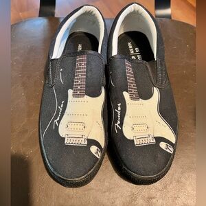 Fender guitar size men’s 8 and women’s 9 slip on black canvas shoes.